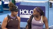 Coco Gauff helps Naomi Osaka walk off the court after she retired from a China Open match.