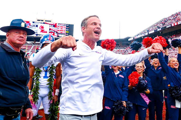 Ole Miss head coach Lane Kiffin celebrates with fans.
