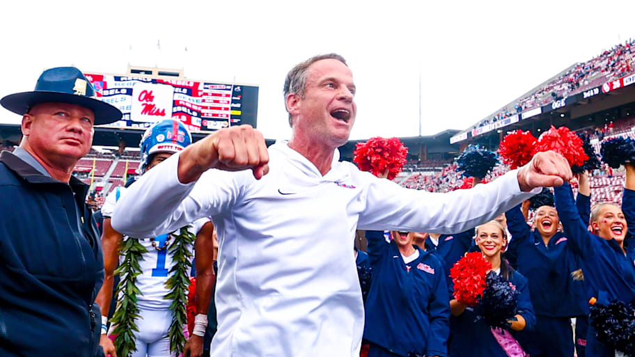 Ole Miss head coach Lane Kiffin celebrates with fans.