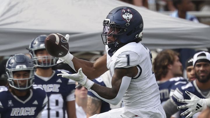 Oct 25, 2025; Houston, Texas, USA; UConn Huskies wide receiver Skyler Bell (1) makes a reception during the second quarter against the Rice Owls at Rice Stadium. Mandatory Credit: Troy Taormina-Imagn Images