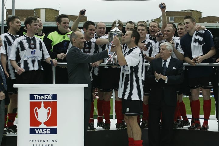 Brigg Town captain Phil Rowland kisses trophy