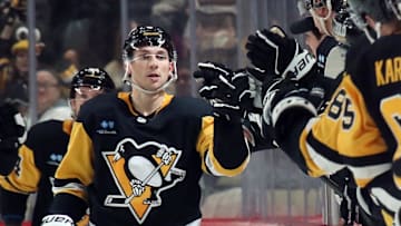 Nov 30, 2024; Pittsburgh, Pennsylvania, USA;  Pittsburgh Penguins left wing Michael Bunting (8) celebrates his goal with the Penguins bench against the Calgary Flames during the second period at PPG Paints Arena. Mandatory Credit: Charles LeClaire-Imagn Images