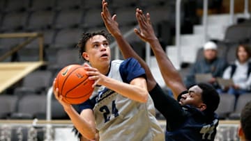 La Lumiere junior Darius Adams looks to put up a shot around teammate Jonas Muya during an open practice Thursday, Nov. 9, 2023, at the La Porte Civic Auditorium.