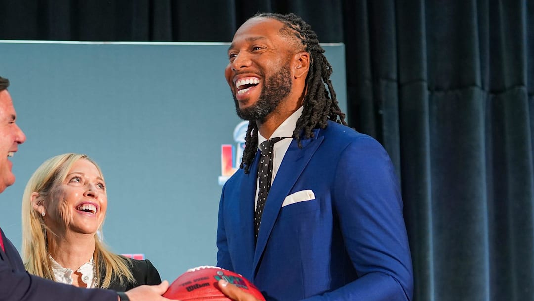 Doug Ducey, governor of Arizona, left, hands off a football to Larry Fitzgerald, former Cardinals wide receiver and executive chairperson of the Arizona Super Bowl host committee, right, as Jay Parry, Arizona Super Bowl Host Committee CEO, center, smiles during the official Super Bowl Host Committee handoff press conference at the Los Angeles Convention Center on Monday, Feb. 14, 2022, in Los Angeles.

Sbhostcomm 02142022 At 011