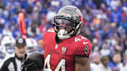 Tampa Bay Buccaneers running back Sean Tucker (44) runs the ball for a touchdown against Buffalo Bills safety Jordan Poyer (21) 
