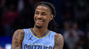 Dec 26, 2023; New Orleans, Louisiana, USA; Memphis Grizzlies guard Ja Morant (12) smiles at a fan as the end of regulation against the New Orleans Pelicans at Smoothie King Center. 