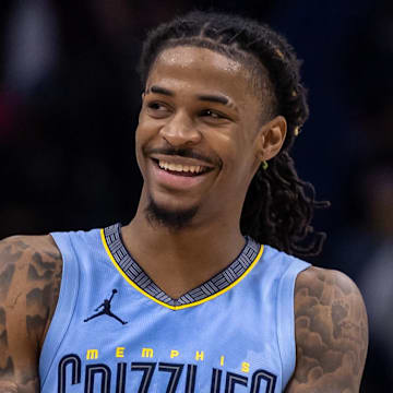 Dec 26, 2023; New Orleans, Louisiana, USA; Memphis Grizzlies guard Ja Morant (12) smiles at a fan as the end of regulation against the New Orleans Pelicans at Smoothie King Center. 