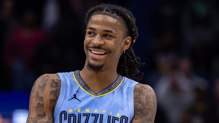 Dec 26, 2023; New Orleans, Louisiana, USA; Memphis Grizzlies guard Ja Morant (12) smiles at a fan as the end of regulation against the New Orleans Pelicans at Smoothie King Center. 