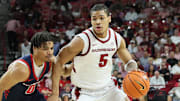 Arkansas Razorbacks guard Darius Acuff Jr (5) drives against Samford Bulldogs guard Isaiah Campbell-Finch (0) during the second half at Bud Walton Arena. Arkansas won 79-75.