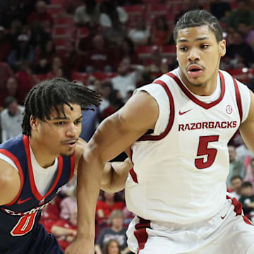 Arkansas Razorbacks guard Darius Acuff Jr (5) drives against Samford Bulldogs guard Isaiah Campbell-Finch (0) during the second half at Bud Walton Arena. Arkansas won 79-75.