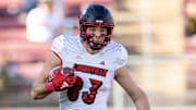 Nov 16, 2024; Stanford, California, USA; Louisville Cardinals tight end Mark Redman (83) runs with the ball during the second quarter against the Stanford Cardinal at Stanford Stadium. Mandatory Credit: Bob Kupbens-Imagn Images
