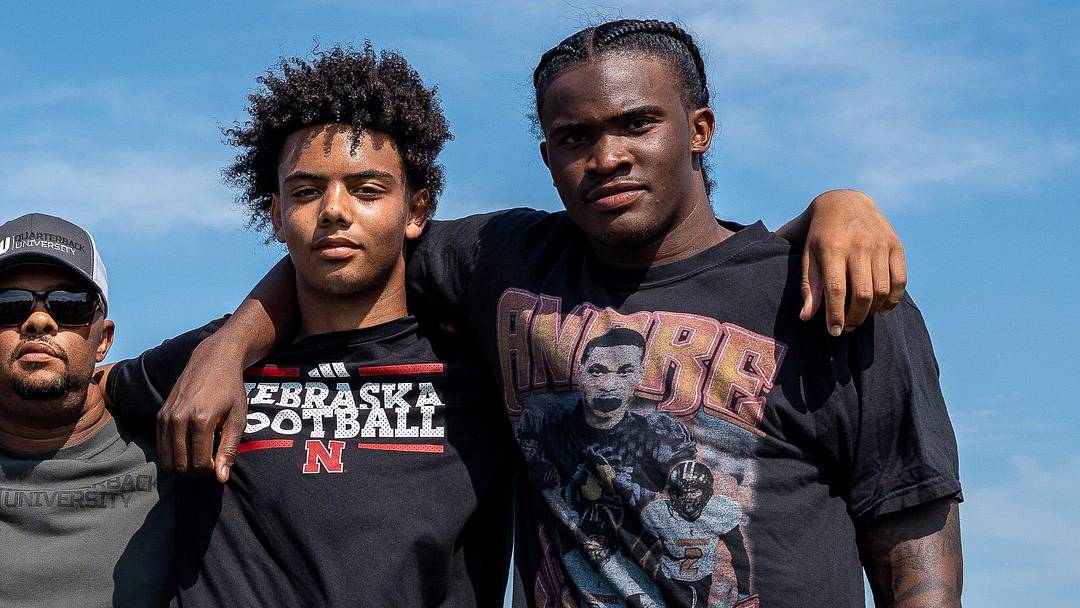 From left to right, Donald Tabron II, 16, Donovan Dooley, 40, owner and founder of Quarterback University, Trae Taylor, 16, and Bryce Underwood, 17, take a photo together after participating in a private workout in Detroit on Saturday, June 21, 2025.