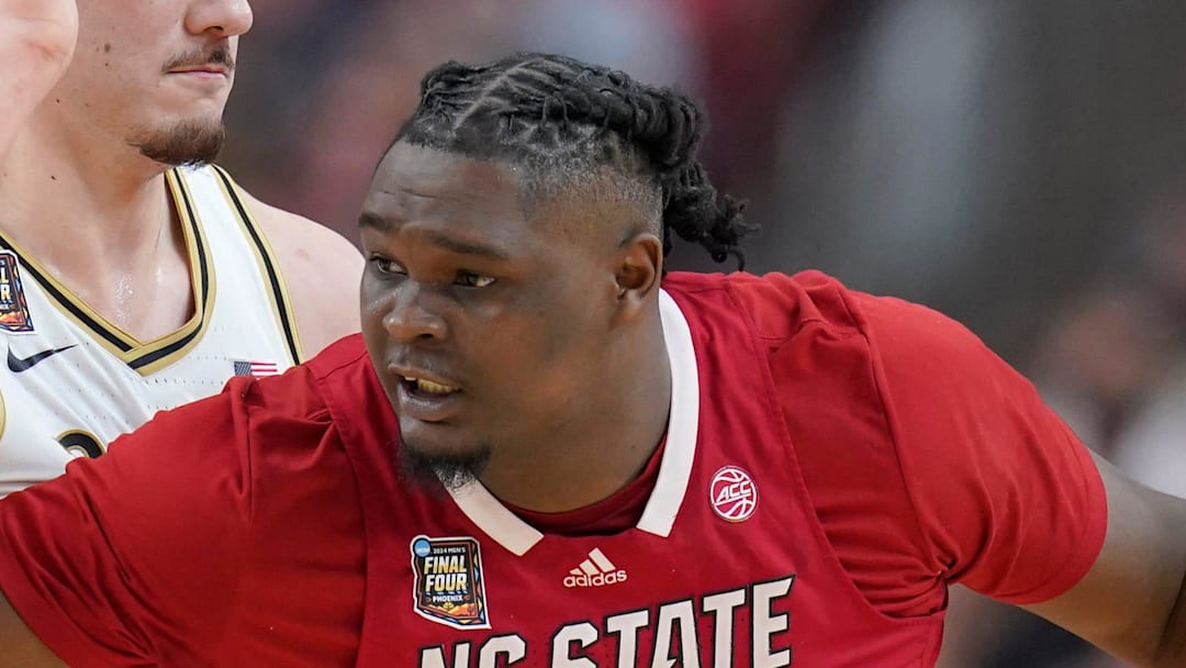 Purdue Boilermakers center Zach Edey (15) defends North Carolina State Wolfpack forward DJ Burns Jr. (30) during the NCAA Men’s Basketball Tournament Final Four game, Saturday, April 6, 2024, at State Farm Stadium in Glendale, Ariz.