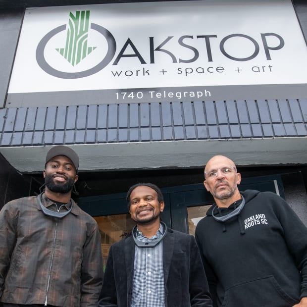 Jaylen Brown (left), Trevor Parham (center), and Jason Kidd (right), smile for a photo in front of Oakstop in Oakland.