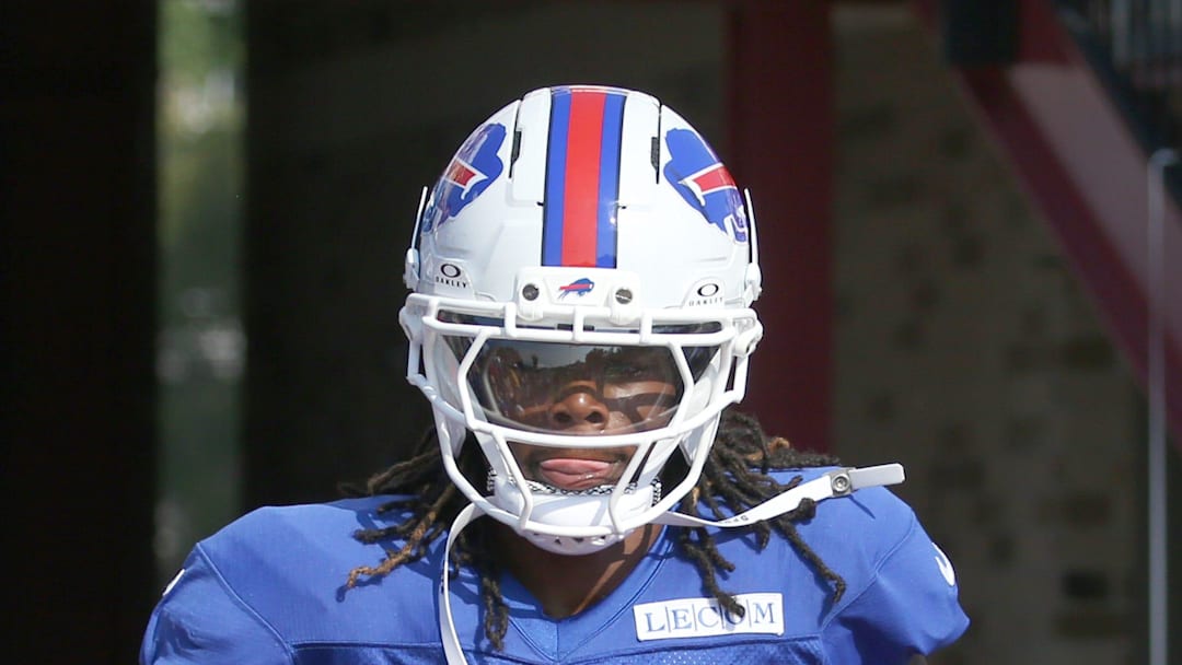 Maxwell Hairston high-fives fans as he runs onto the field during day five of Buffalo Bills training camp.