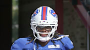 Maxwell Hairston high-fives fans as he runs onto the field during day five of Buffalo Bills training camp.