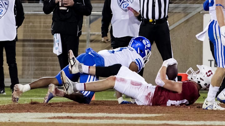 Nov 26, 2022; Stanford, California, USA;  Stanford Cardinal tight end Benjamin Yurosek (84) scores a touchdown against Brigham Young Cougars defensive back Micah Harper (1) during the second half at Stanford Stadium.