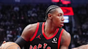 RJ Barrett of the Toronto Raptors dribbles against Justin Champagnie of the Washington Wizards.