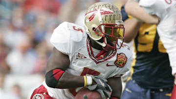 Jan 01, 2005; Jacksonville, FL, USA;  Florida State Seminoles runningback Leon Washington runs past the West Virginia Mountaineers defenders during the first quarter in the 2005 Toyota Gator Bowl held at Alltel Stadium. FSU defeated West Virginia 30-18. Mandatory Credit: Photo by Imagn Images (©) Copyright 2004 by Preston Mack