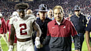Nov 25, 2023; Auburn, Alabama, USA;  Alabama Crimson Tide defensive back Caleb Downs (2) and head coach Nick Saban grasp hands as they walk off the field following a victory over the Auburn Tigers at Jordan-Hare Stadium. Alabama won 27-24. Mandatory Credit: Gary Cosby Jr.-Imagn Images