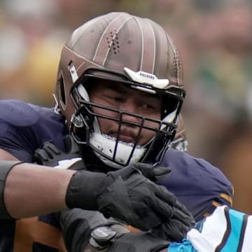 Green Bay Packers guard Aaron Banks (65) blocks Carolina Panthers defensive end Derrick Brown.