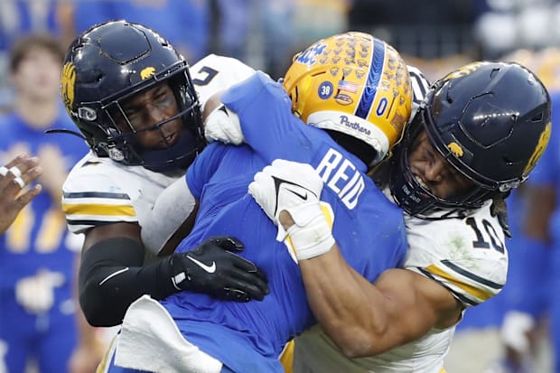 Craig Woodson, left, and Teddye Buchanan combine for a tackle vs. Pittsburgh.