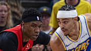 Indiana Pacers guard/forward Andrew Nembhard holds the ball while Toronto Raptors guard Ja'Kobe Walter defends.
