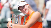 Mirra Andreeva poses with the Indian Wells trophy after winning the title.