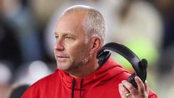 Nov 21, 2024; Atlanta, Georgia, USA; North Carolina State Wolfpack head coach Dave Doeren talks to a referee against the Georgia Tech Yellow Jackets in the fourth quarter at Bobby Dodd Stadium at Hyundai Field. Mandatory Credit: Brett Davis-Imagn Images