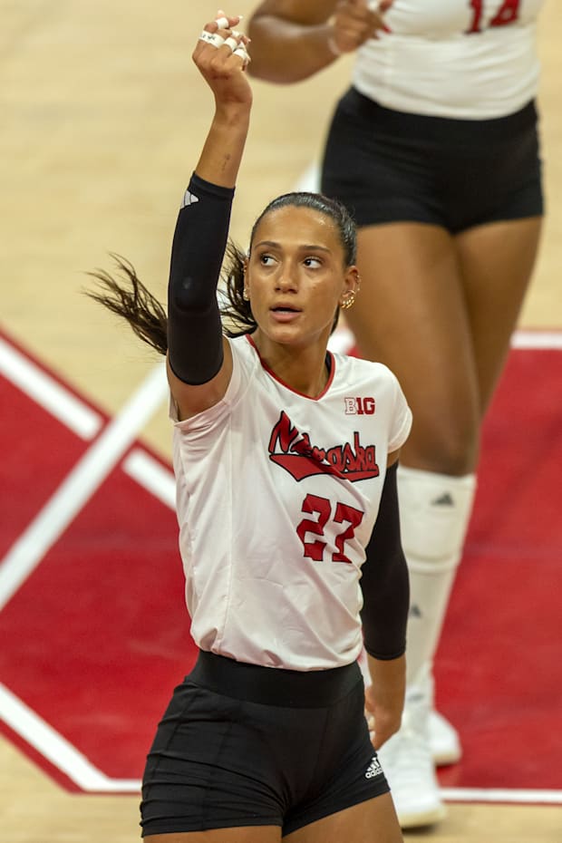 Nebraska outside hitter Harper Murray motions to the referee that her spike was touched by the defense.
