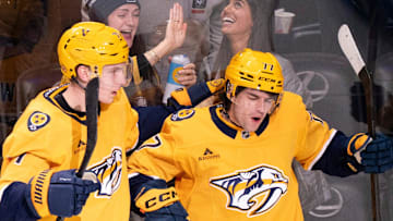 Nashville right wing Matthew Wood (71) and right wing Luke Evangelista (77) celebrate Evangelista’s first goal of the year against Tampa Bay during their game at Bridgestone Arena in Nashville, Tenn., Tuesday, Oct. 28, 2025.