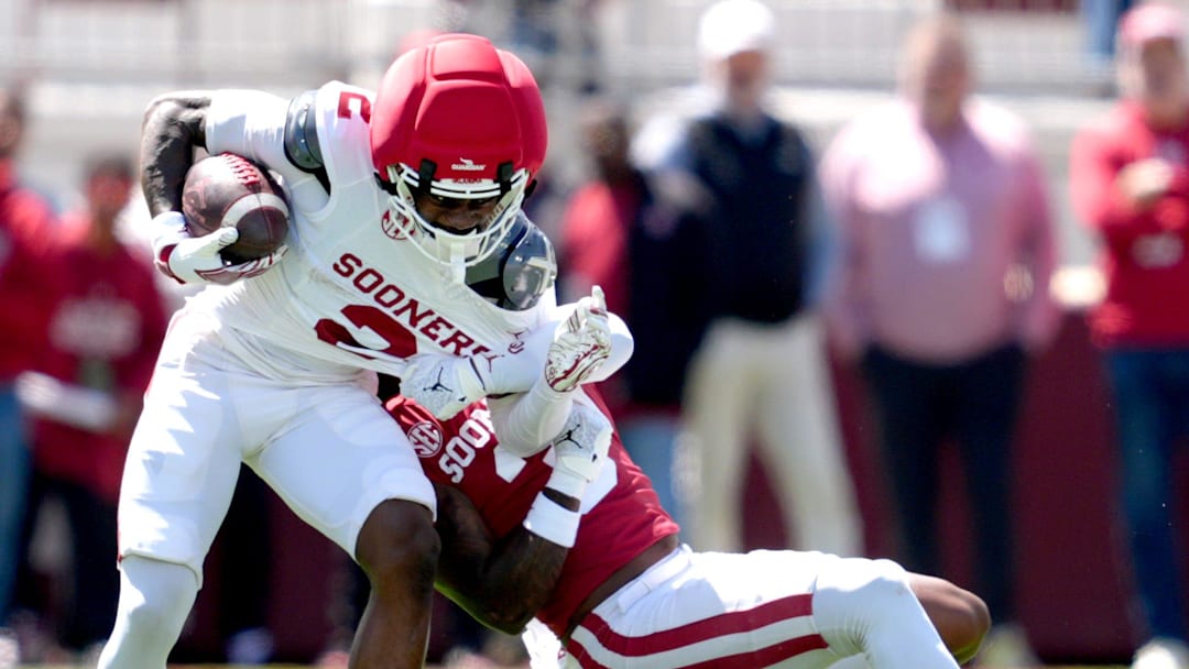 Oklahoma's Jahsiear Rogers (2) makes a catch as Reggie Powers III (3) tackles him during the University of Oklahoma Sooners Spring Game at the Gaylord Family - Oklahoma Memorial Stadium in Norman, Okla., Saturday April 18, 2026.