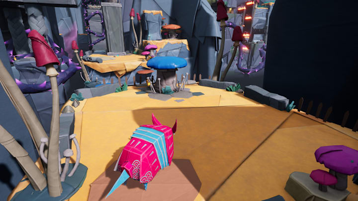 A papercraft world being explored by a pink origami armadillo.