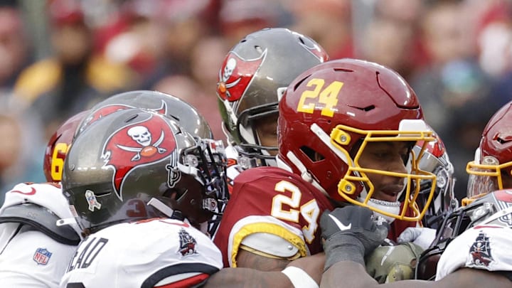 Nov 14, 2021; Landover, Maryland, USA;Washington Football Team running back Antonio Gibson (24). Is tackled by Tampa Bay Buccaneers inside linebacker Lavonte David (54) and Buccaneers free safety Jordan Whitehead (33)  at FedExField. Mandatory Credit: Geoff Burke-USA TODAY Sports