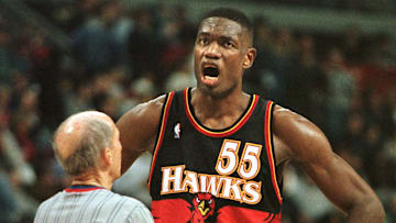 Dikembe Mutombo argues with a referee