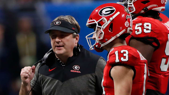 Georgia coach Kirby Smart speaks with Georgia quarterback Stetson Bennett (13) during the second half of the Chick-fil-A Peach Bowl NCAA College Football Playoff semifinal game between Ohio State and Georgia on Saturday, Dec 31, 2022, in Atlanta. Georgia won 42-41.

News Joshua L Jones