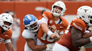 Texas Longhorns quarterback Arch Manning (16) and San Jose State Spartans linebacker Taniela Latu (4).