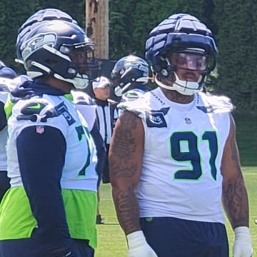 Seattle Seahawks rookie Byron Murphy looks on as an assistant coach instructs on an upcoming drill during mandatory minicamp.