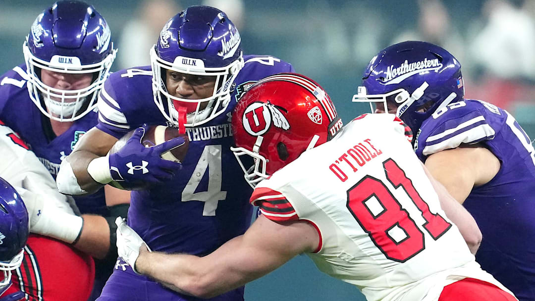 Dec 23, 2023; Las Vagas, NV, USA; Northwestern Wildcats running back Cam Porter (4) is tackled by Utah Utes defensive end Connor O'Toole (81) during the first quarter at Allegiant Stadium.