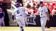 Noah Franco celebrates with 3rd base coach, Bill Mosiello, after a homerun. 