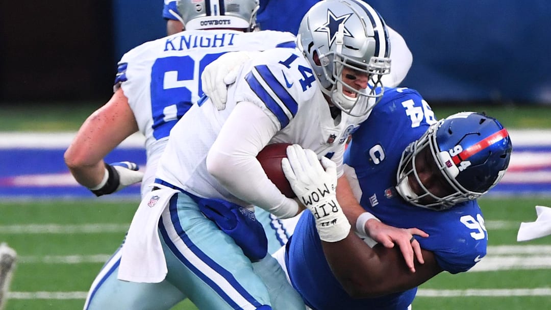 Jan 3, 2021; East Rutherford, NJ, USA; Dallas Cowboys quarterback Andy Dalton (14) is sacked by New York Giants nose tackle Dalvin Tomlinson (94) in the first half at MetLife Stadium. Mandatory Credit: Robert Deutsch-Imagn Images