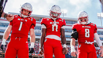 Oct 4, 2025; Raleigh, North Carolina, USA; NC State Wolfpack quarterback CJ Bailey (11), linebacker Caden Fordham (1), wide receiver Keenan Jackson (8) during the coin toss prior to the first half of the game against Campbell Fighting Camels at Carter-Finley Stadium. Mandatory Credit: Jaylynn Nash-Imagn Images