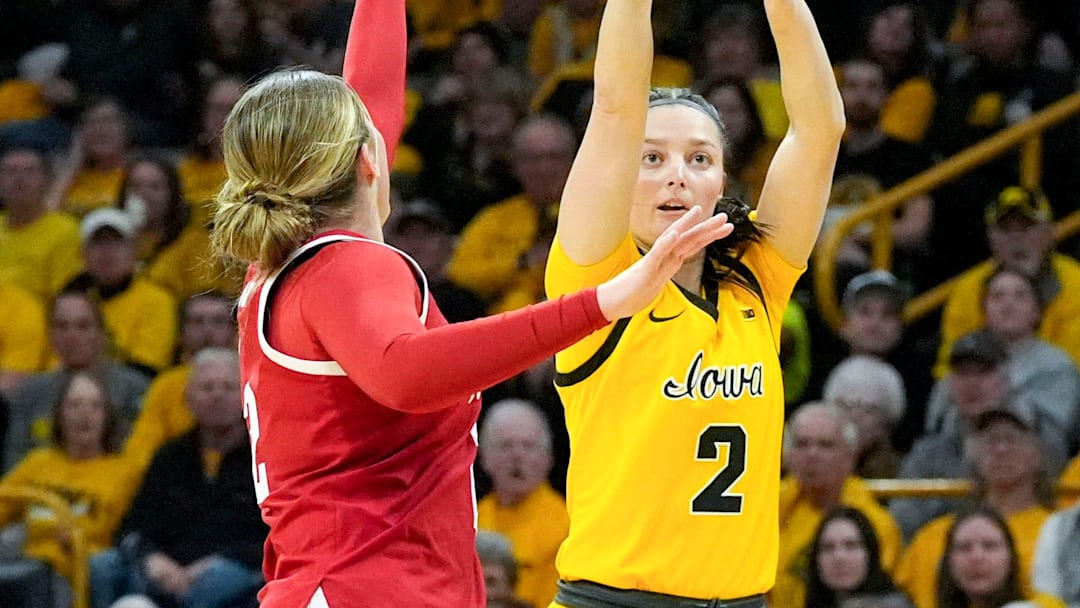 Iowa guard Taylor McCabe attempts a three-pointer against Nebraska guard Logan Nissley.