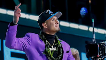 Wide receiver Tetairoa McMillan celebrates as he walks on stage after being selected eighth overall by the Carolina Panthers during the first round of the 2025 NFL Draft on Thursday, April 24, 2025, at Lambeau Field in Green Bay, Wisconsin. 