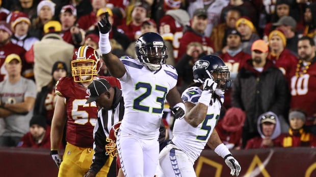 Seattle Seahawks cornerback Marcus Trufant (23) and Seahawks defensive end Bruce Irvin (51) celebrate.