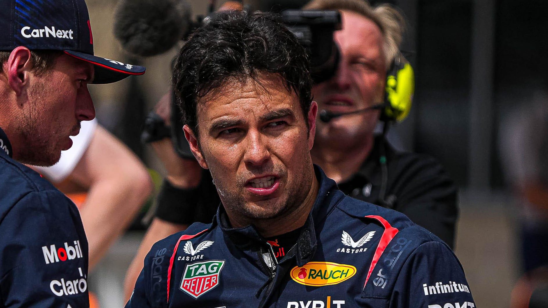 Oracle Red Bull Racing driver Max Verstappen, left, talks to Sergio Perez, right, after the Sprint