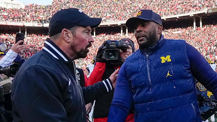 Ohio State Buckeyes head coach Ryan Day shakes hands with Michigan Wolverines head coach Sherrone Moore following Michigan's 13-10 victory.