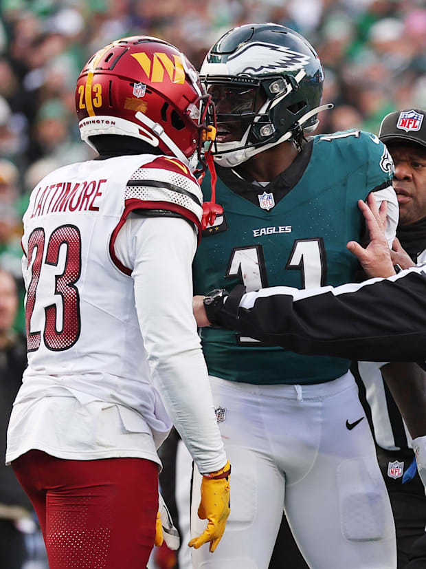 Philadelphia Eagles quarterback Jalen Hurts (1) talks with Washington Commanders cornerback Marshon Lattimore (23).