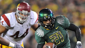 Oct 31, 2009; Eugene, OR, USA; Oregon Ducks running back LaMichael James (21) is pursued by Southern California Trojans nose tackle Christian Tupou (44) at Autzen Stadium. Oregon defeated USC 47-20. Mandatory Credit: Kirby Lee/Image of Sport-Imagn Images