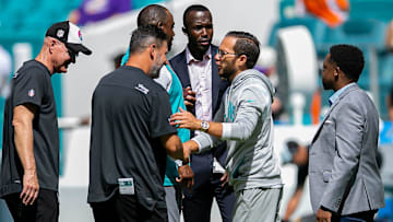Miami Dolphins head coach Mike McDaniel, shakes hands with members of the Vikings coaching staff